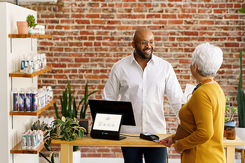 Man paying for item with credit card at a hair salon
